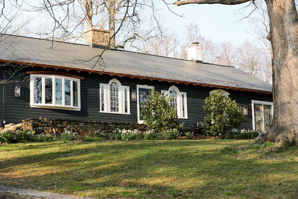 Mid-sized traditional one-storey grey house exterior in DC Metro with wood siding and a metal roof.