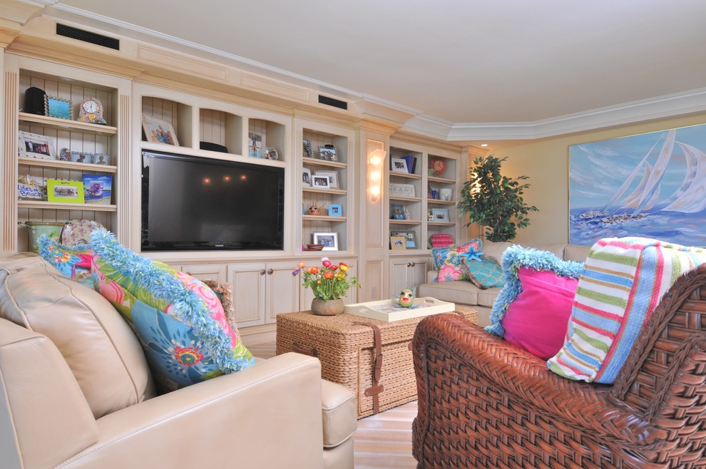 Inspiration for an expansive traditional open concept living room in Tampa with a library, yellow walls, light hardwood floors, no fireplace and a built-in media wall.