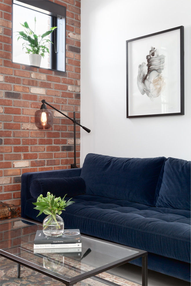 This is an example of a mid-sized contemporary loft-style living room in Vancouver with brick walls.