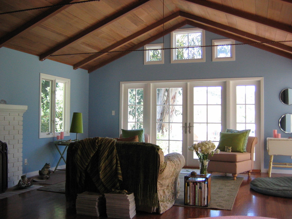 Design ideas for a country family room in San Francisco with blue walls, dark hardwood floors and a standard fireplace.