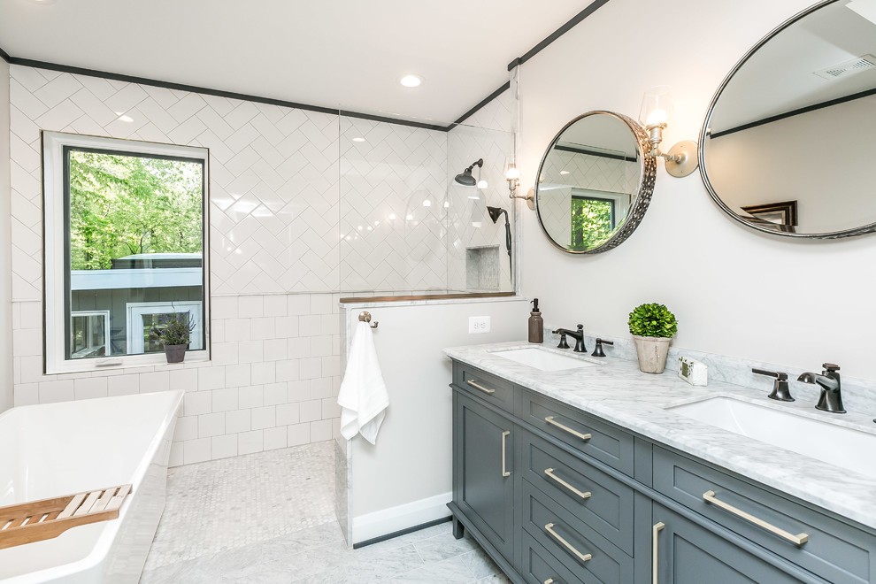 Design ideas for a transitional master bathroom in Baltimore with shaker cabinets, grey cabinets, a freestanding tub, an open shower, white tile, subway tile, white walls, marble floors, marble benchtops, an open shower, an undermount sink, grey floor and grey benchtops.