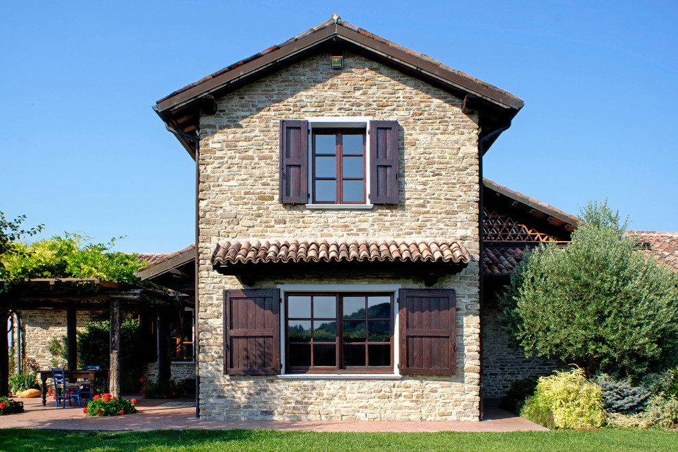 Inspiration for a mid-sized country two-storey brick exterior in Naples with a gable roof.