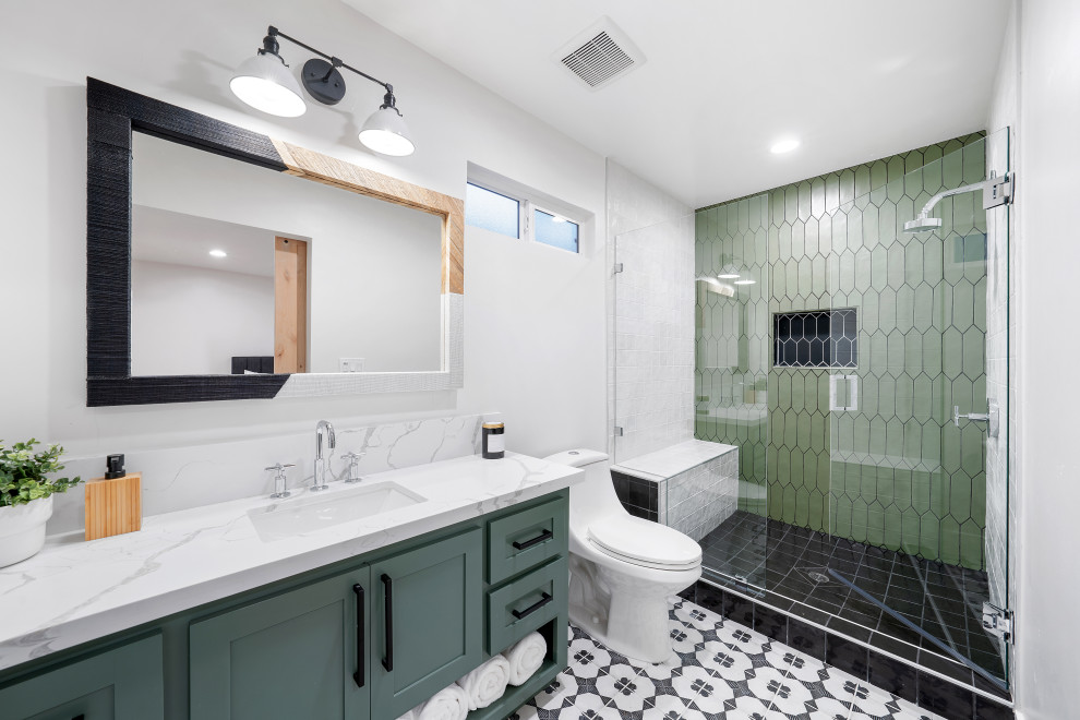 Inspiration for a mid-sized transitional 3/4 bathroom in Sacramento with shaker cabinets, green cabinets, a one-piece toilet, ceramic floors, an undermount sink, engineered quartz benchtops, black floor, white benchtops, a single vanity, a floating vanity and white walls.
