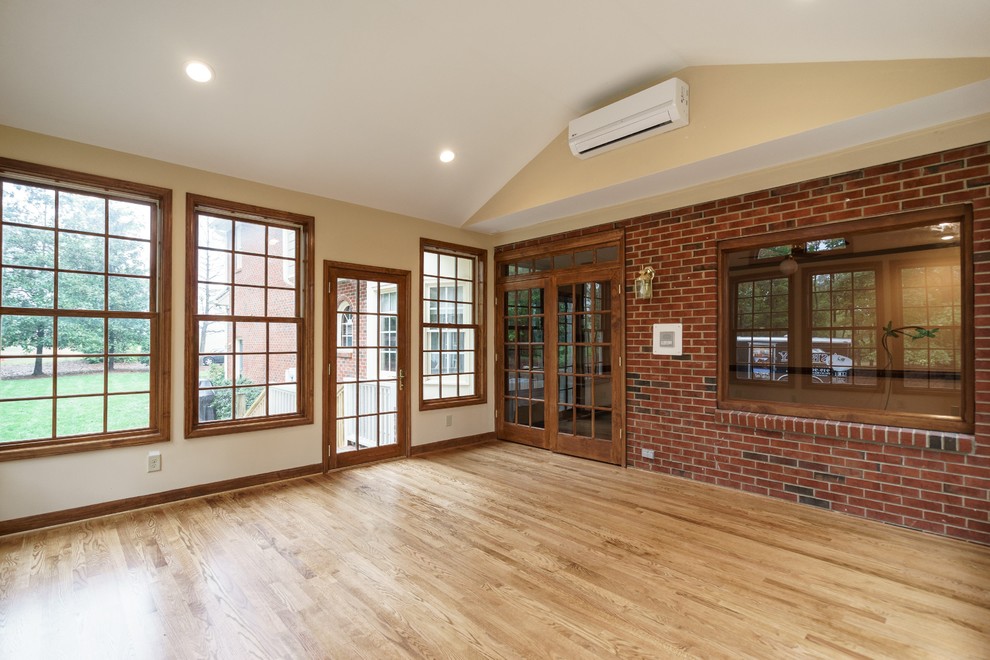 This is an example of a mid-sized traditional sunroom in Raleigh with light hardwood floors and a standard ceiling.