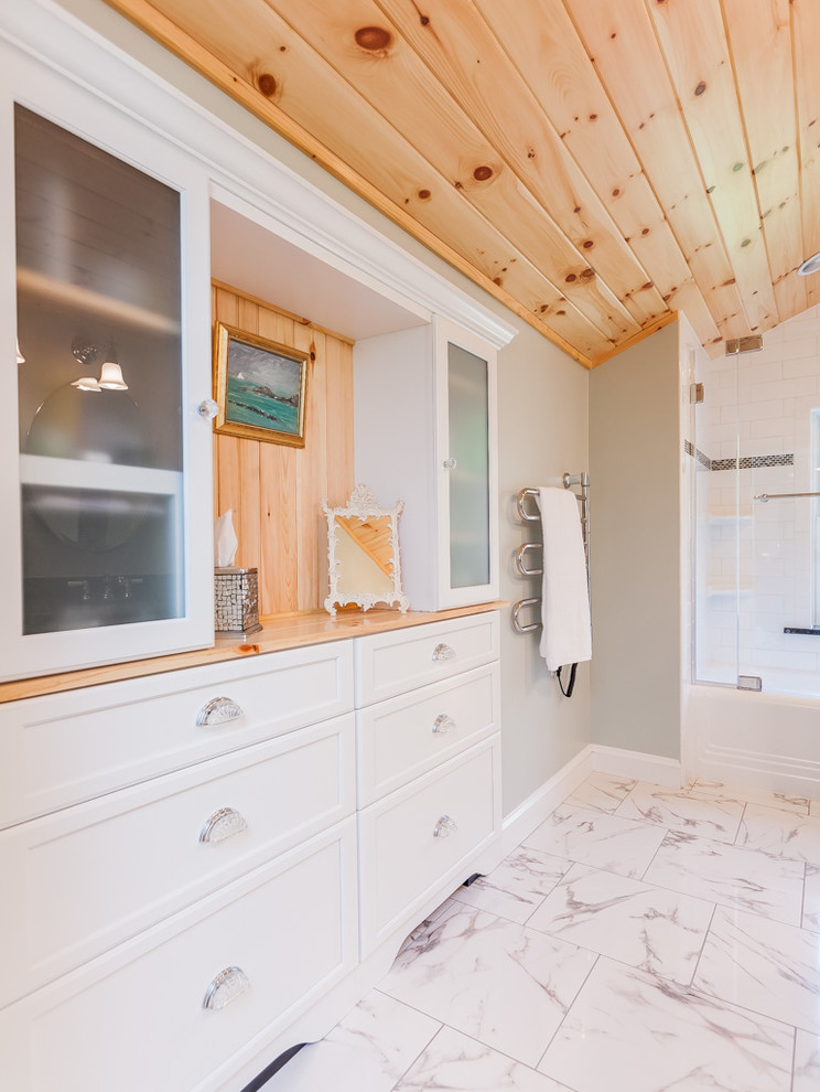 Inspiration for a mid-sized traditional master bathroom in Boston with an undermount sink, white cabinets, granite benchtops, an alcove tub, a shower/bathtub combo, a two-piece toilet, white tile, porcelain tile, recessed-panel cabinets, grey walls and a hinged shower door.