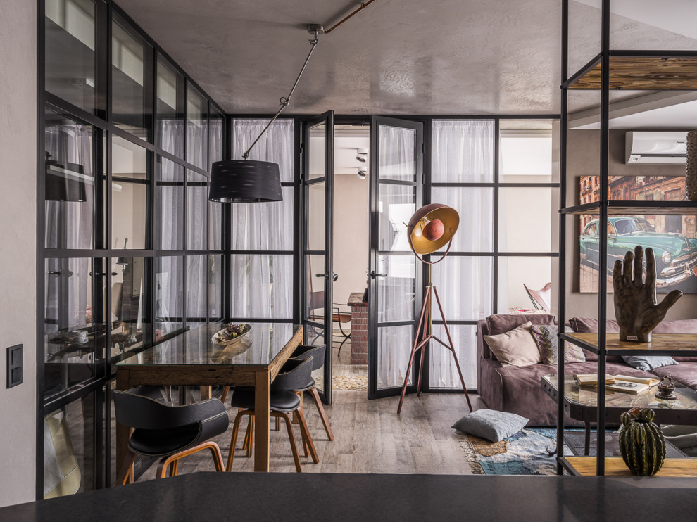 Design ideas for an industrial dining room in Saint Petersburg with grey floor.