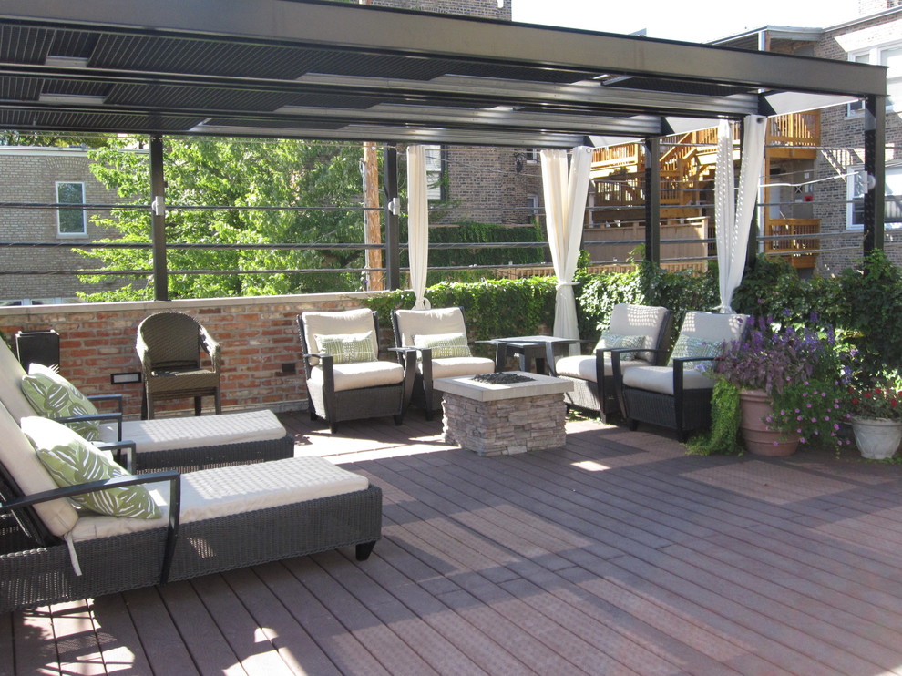This is an example of a small transitional rooftop deck in Chicago with a pergola.