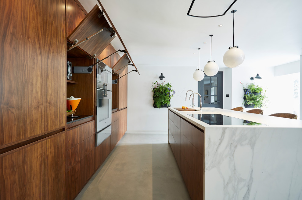 Inspiration for a mid-sized contemporary single-wall kitchen in Devon with flat-panel cabinets, dark wood cabinets, marble benchtops, panelled appliances, concrete floors, a peninsula and grey floor.