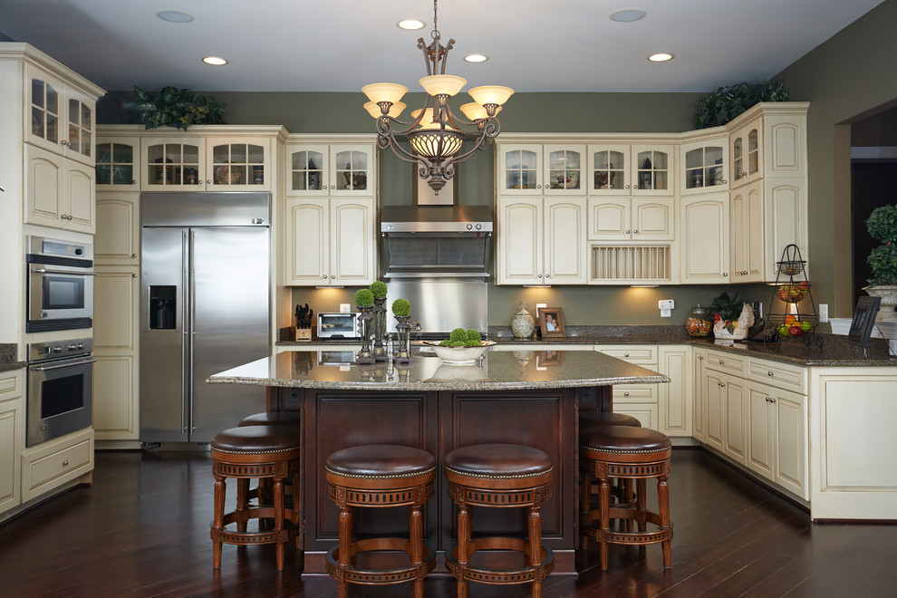 Design ideas for a traditional kitchen in Salt Lake City with raised-panel cabinets, beige cabinets, dark hardwood floors and with island.