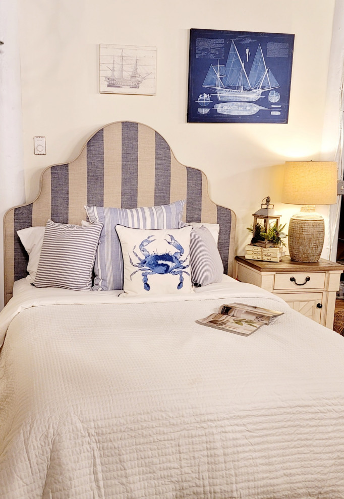 Ispirazione per una camera degli ospiti stile marinaro di medie dimensioni con pareti beige e pavimento in legno massello medio