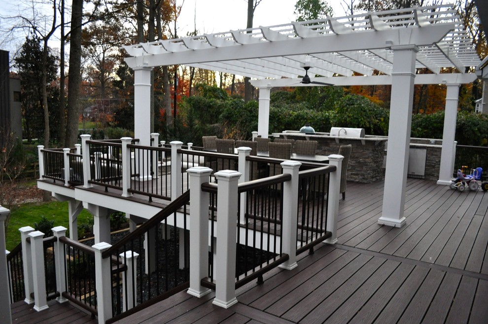 Photo of a large traditional backyard deck in DC Metro with an outdoor kitchen and a pergola.
