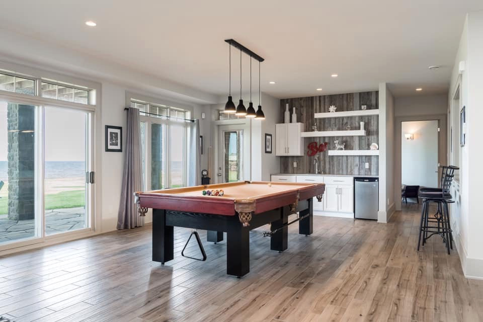 Inspiration for a large transitional walk-out porcelain tile and gray floor basement remodel with gray walls