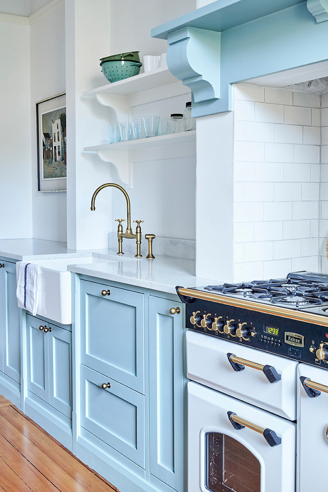 Inspiration for a mid-sized traditional u-shaped eat-in kitchen in Sydney with a farmhouse sink, shaker cabinets, turquoise cabinets, marble benchtops, white splashback, subway tile splashback, stainless steel appliances, medium hardwood floors and with island.