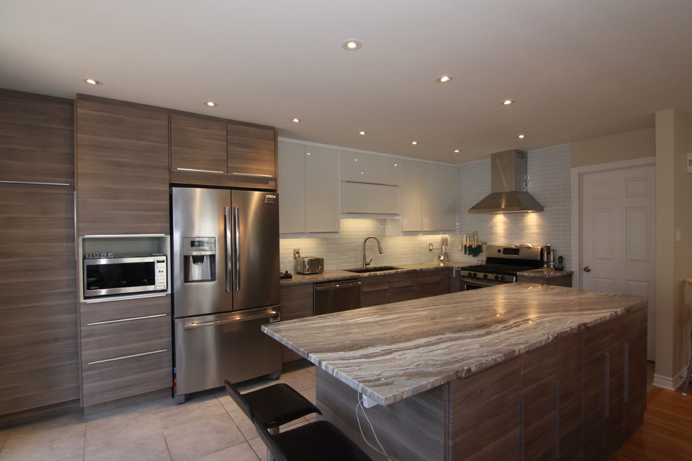 Inspiration for a large contemporary u-shaped eat-in kitchen in Montreal with an undermount sink, glass-front cabinets, brown cabinets, granite benchtops, white splashback, glass tile splashback, stainless steel appliances, ceramic floors and with island.