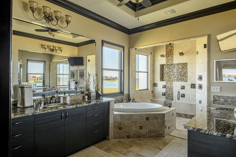 Design ideas for a large eclectic master bathroom in Orlando with flat-panel cabinets, dark wood cabinets, a corner tub, a double shower, beige tile, stone tile, beige walls, travertine floors, an undermount sink and granite benchtops.
