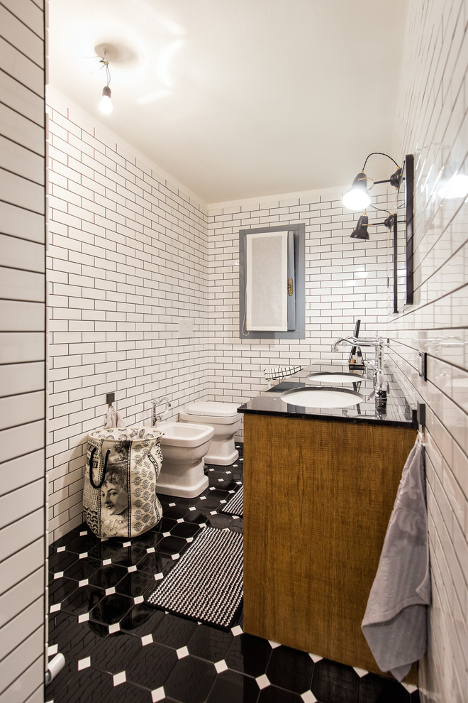 Photo of a mid-sized traditional bathroom in Venice with black and white tile, ceramic tile, ceramic floors, an undermount sink, marble benchtops and medium wood cabinets.