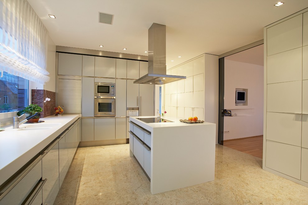 Inspiration for a large contemporary l-shaped separate kitchen in Hamburg with an integrated sink, glass-front cabinets, grey cabinets, solid surface benchtops, multi-coloured splashback, mosaic tile splashback, stainless steel appliances, marble floors, with island and beige floor.