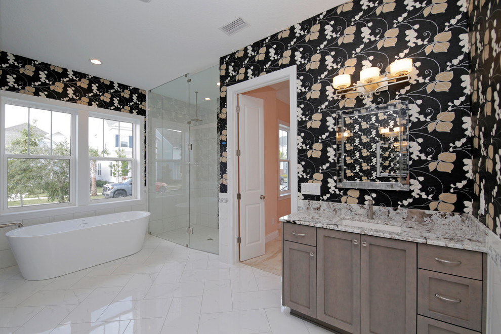 This is an example of a large transitional master bathroom in Orlando with shaker cabinets, brown cabinets, a freestanding tub, a corner shower, multi-coloured walls, an undermount sink, white floor, a hinged shower door and grey benchtops.