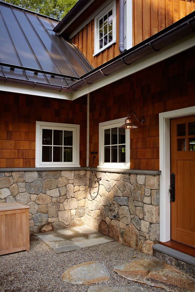 This is an example of a country patio in New York with an outdoor shower.