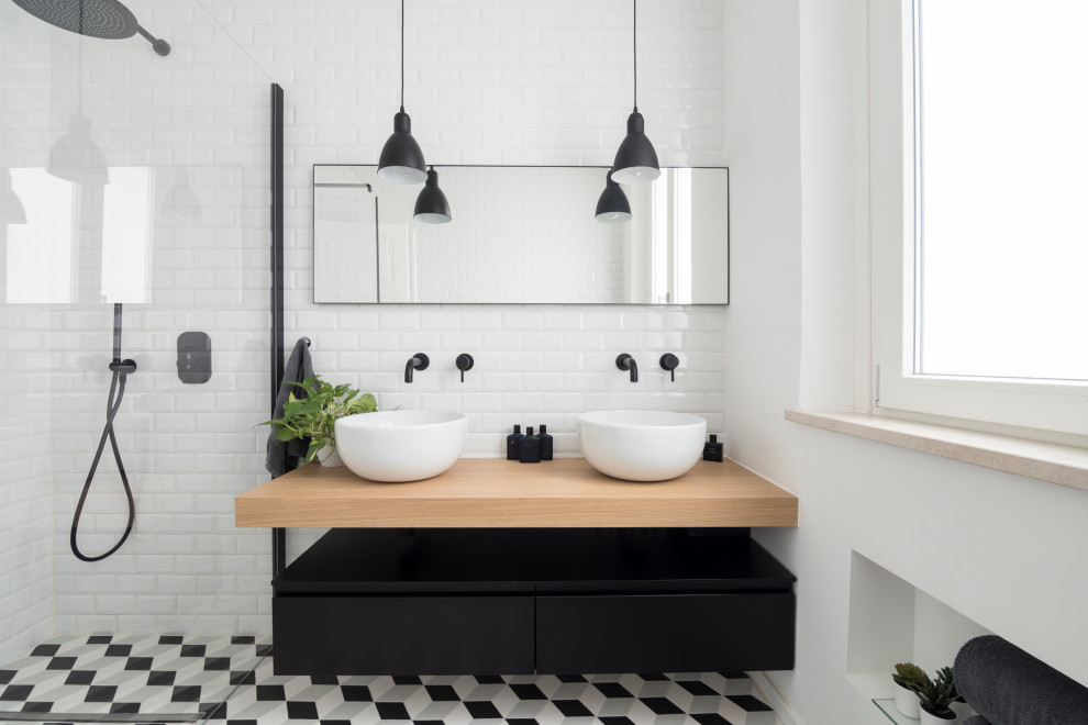 Photo of a contemporary 3/4 bathroom in Cagliari with black cabinets, a curbless shower, a two-piece toilet, white tile, subway tile, white walls, cement tiles, a vessel sink, wood benchtops, multi-coloured floor, a hinged shower door, yellow benchtops, a niche, a double vanity and a floating vanity.