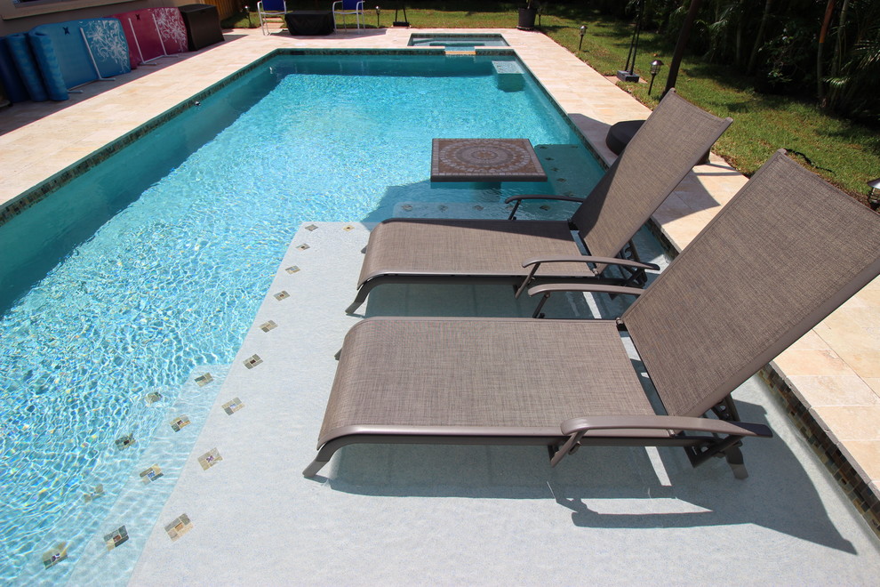 Pool fountain - mid-sized transitional backyard pool fountain idea in Miami with no cover