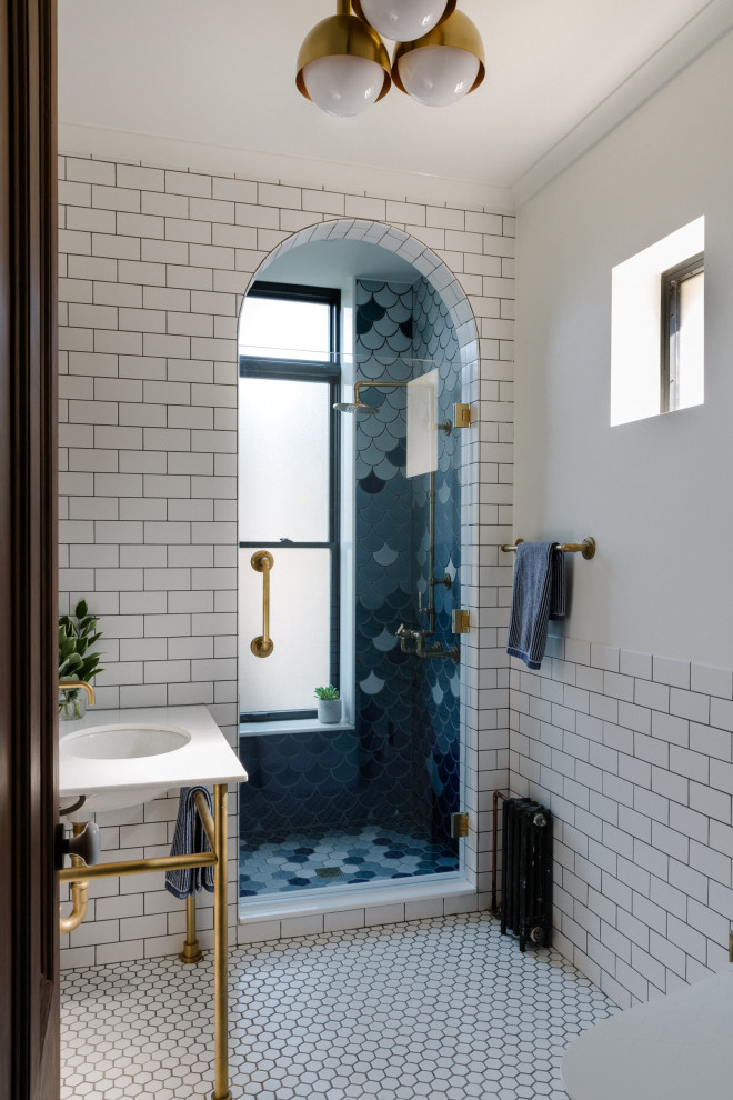 Inspiration for a mid-sized multicolored tile and ceramic tile ceramic tile and white floor corner shower remodel in New York with a hinged shower door