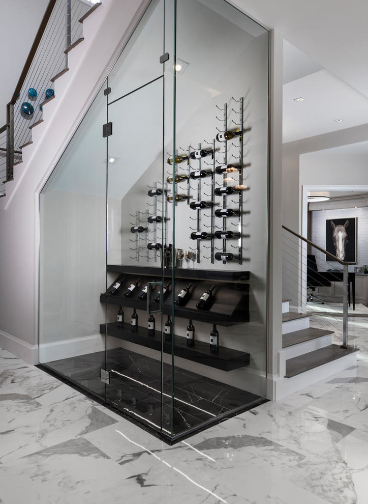 Mid-sized contemporary wine cellar in Miami with display racks and black floor.