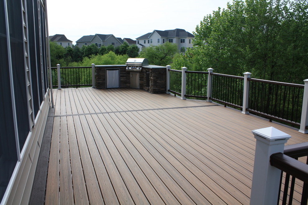 Photo of a large traditional backyard deck in DC Metro with an outdoor kitchen and no cover.