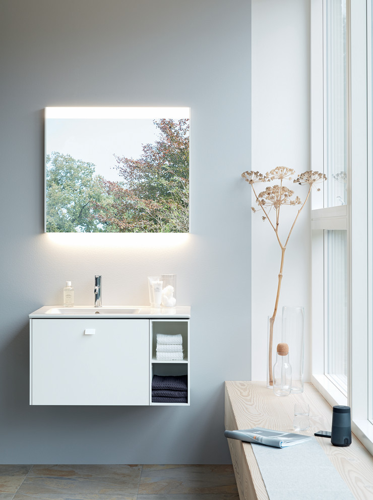 Design ideas for a small contemporary powder room with white cabinets and a console sink.