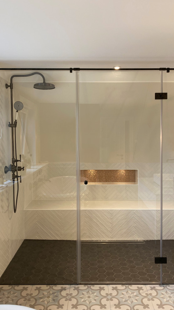 Photo of a large country ensuite bathroom in Other with shaker cabinets, light wood cabinets, a freestanding bath, a built-in shower, a two-piece toilet, metro tiles, white walls, white worktops, a shower bench and a single sink.