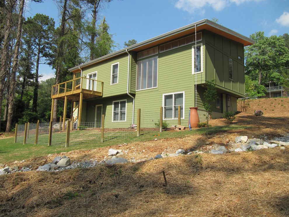 Photo of a modern two-storey green exterior in Atlanta with mixed siding.