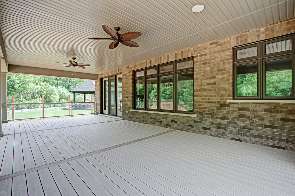 Example of a mid-sized transitional backyard deck design in Toronto with a roof extension