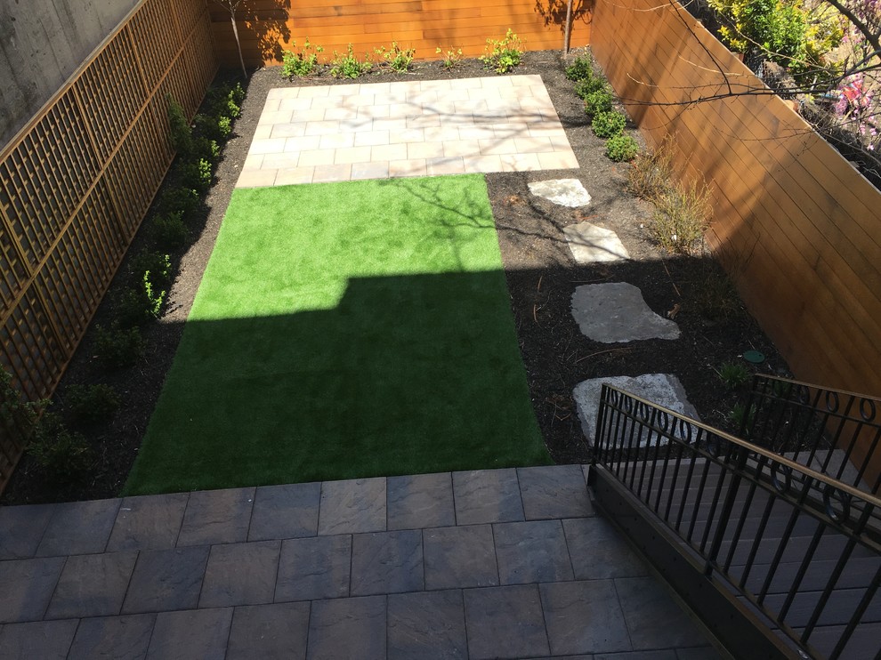 Photo of a mid-sized modern backyard full sun garden in New York with concrete pavers.