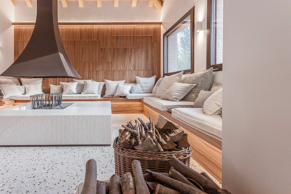 This is an example of a contemporary family room in Venice with white walls and white floor.