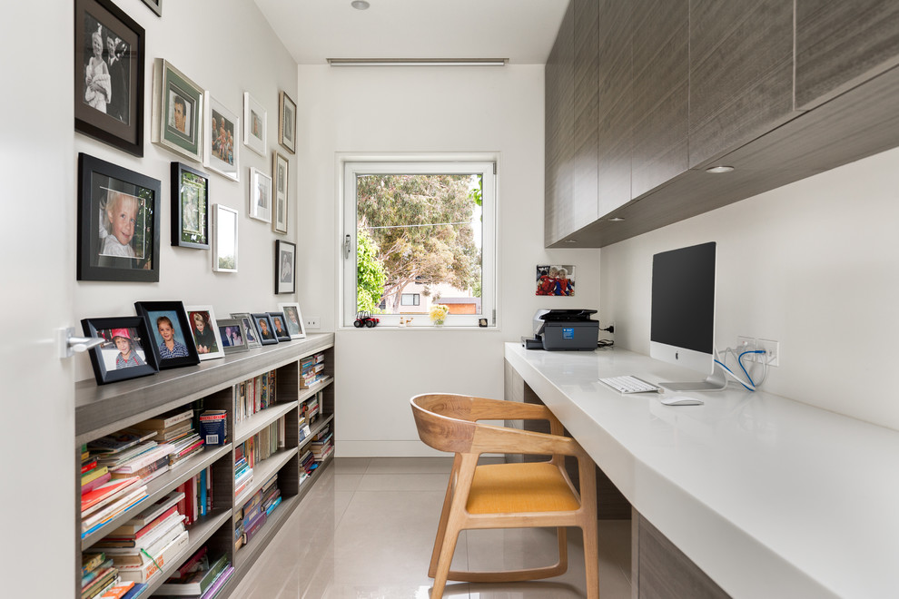 Photo of a contemporary study room in Geelong with white walls, a built-in desk and beige floor.