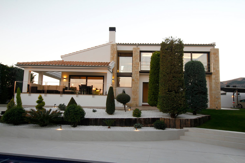 Design ideas for a large modern backyard full sun driveway in Alicante-Costa Blanca with concrete pavers.
