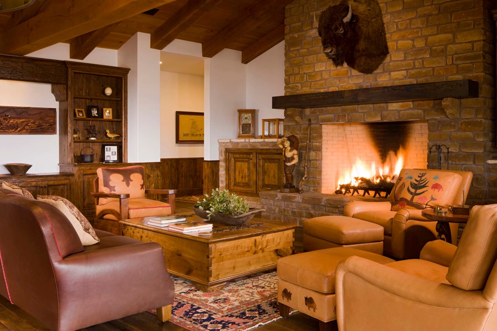 Photo of a mid-sized country open concept family room in Phoenix with a stone fireplace surround, white walls, dark hardwood floors, a standard fireplace and brown floor.