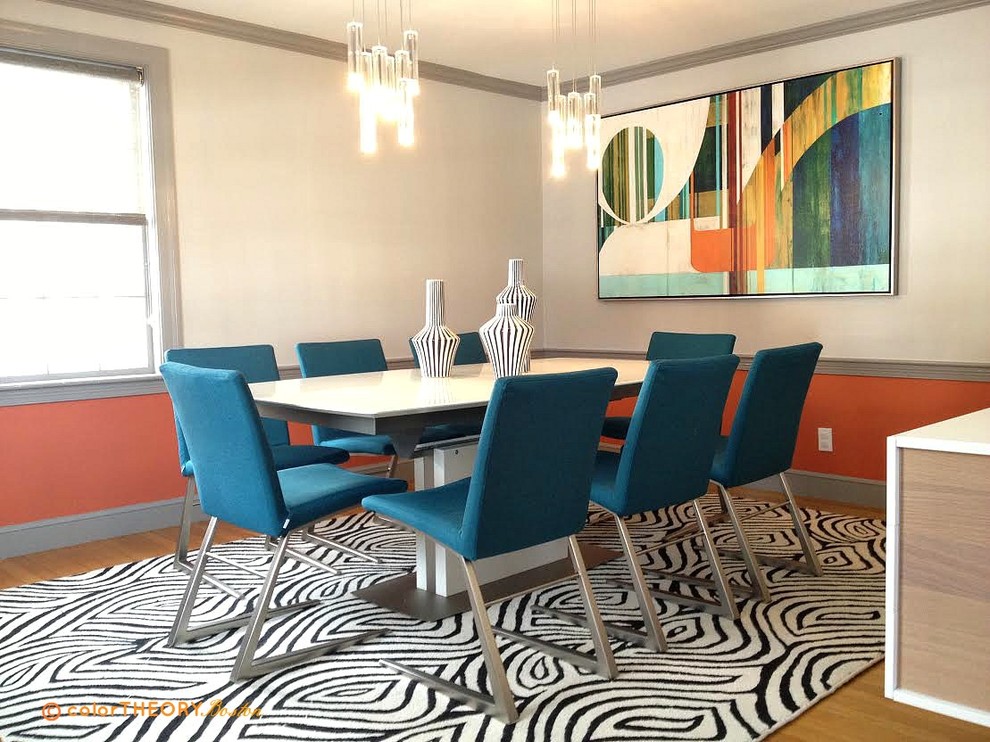 This is an example of a mid-sized contemporary separate dining room in Boston with orange walls, light hardwood floors and no fireplace.