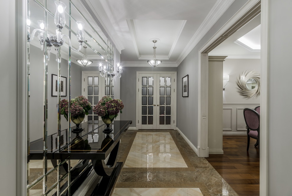 Photo of a large traditional hallway in Moscow with grey walls and porcelain floors.