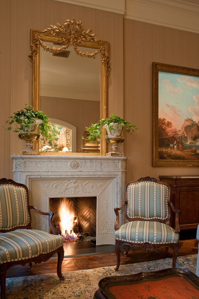 Photo of a mid-sized mediterranean formal enclosed living room in Houston with beige walls, carpet, a standard fireplace, a plaster fireplace surround and no tv.