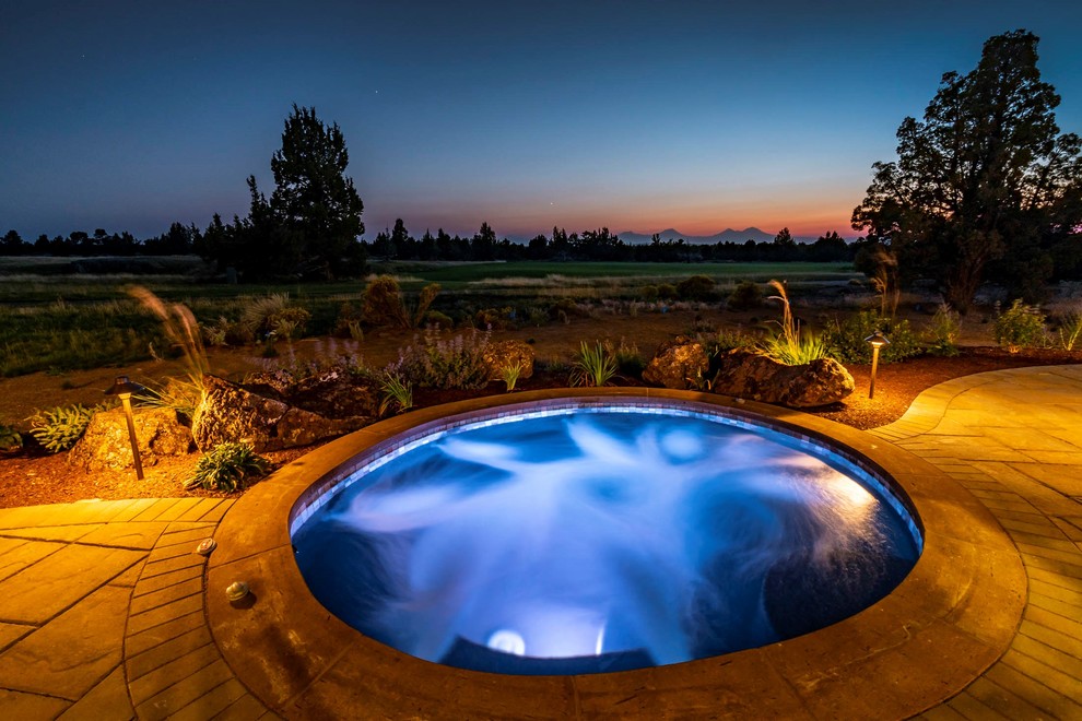 Pool - large rustic backyard stone pool idea with a fireplace and a roof extension