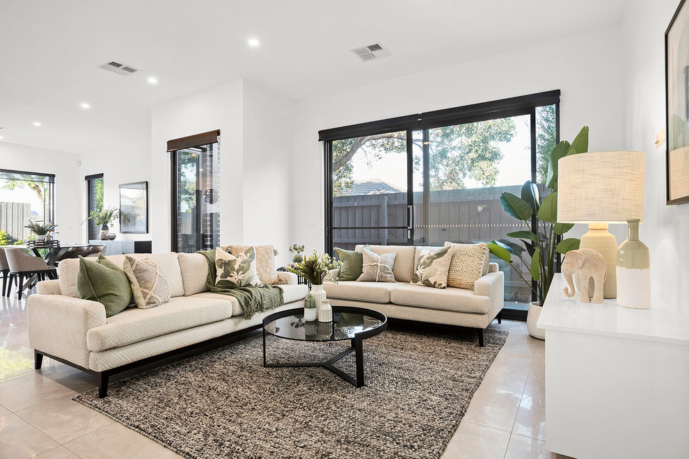 Design ideas for a transitional open concept living room in Melbourne with white walls and beige floor.