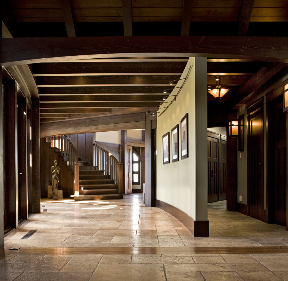 Photo of a mid-sized arts and crafts hallway in Calgary with travertine floors.