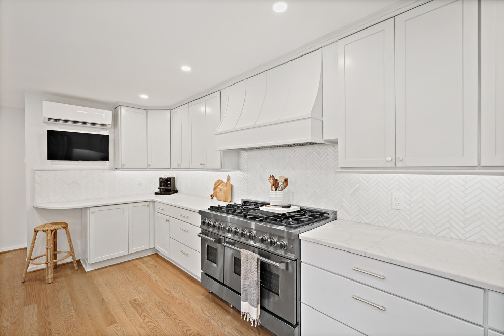 Inspiration for a large contemporary u-shaped eat-in kitchen remodel in DC Metro with a drop-in sink, recessed-panel cabinets, white cabinets, quartz countertops, white backsplash, no island, white countertops and stainless steel appliances