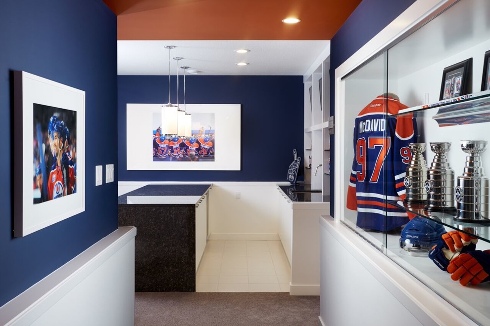 This is an example of a large contemporary open concept family room in Toronto with a game room, blue walls, carpet, a wall-mounted tv and blue floor.