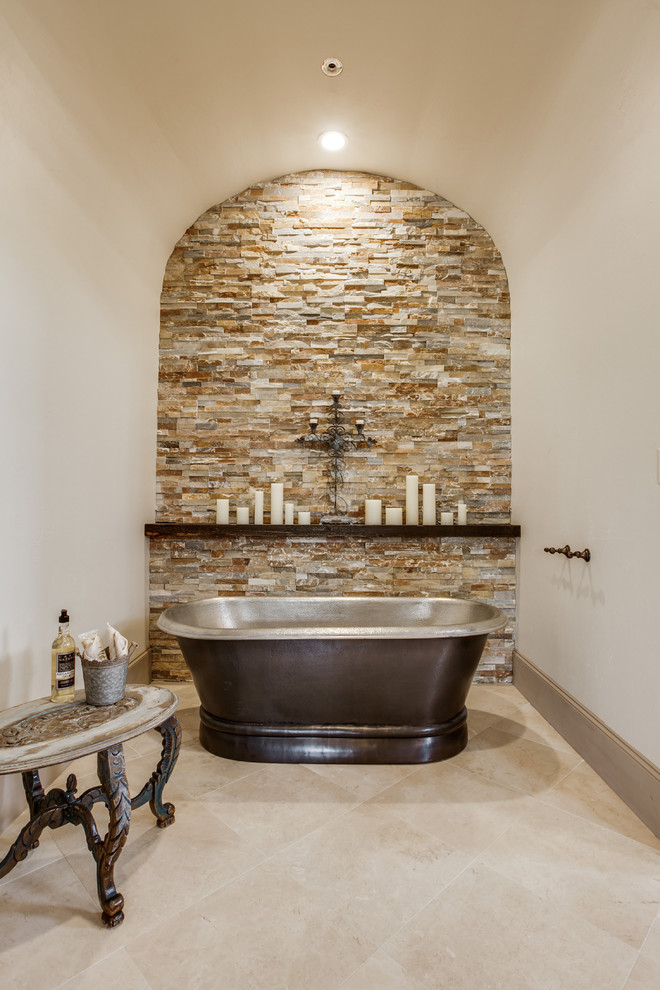 Photo of a mid-sized mediterranean master bathroom in Dallas with an undermount sink, raised-panel cabinets, dark wood cabinets, granite benchtops, a freestanding tub, an alcove shower, a one-piece toilet, beige tile, porcelain tile, beige walls and porcelain floors.