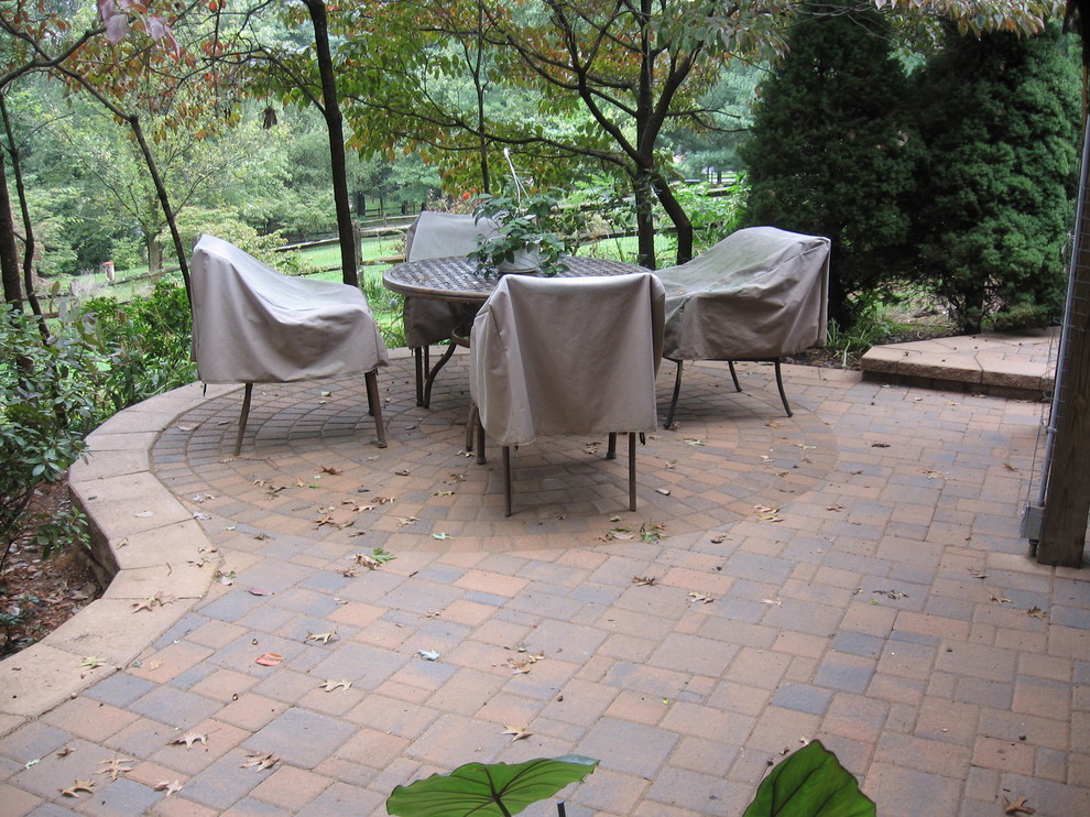 Mid-sized backyard patio in DC Metro with concrete pavers.