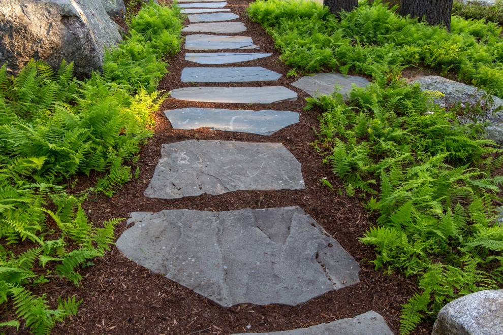 Inspiration for a mid-sized rustic partial sun backyard stone landscaping in Manchester for summer.