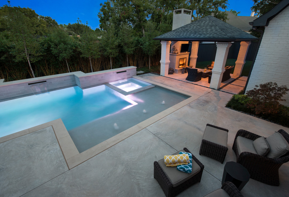 Design ideas for a mid-sized modern backyard custom-shaped lap pool in Dallas with a hot tub and concrete slab.
