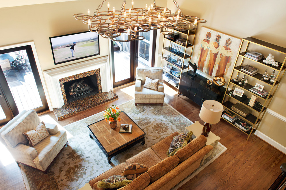 Photo of a transitional formal open concept living room in Other with a standard fireplace, a tile fireplace surround, beige walls, medium hardwood floors, a wall-mounted tv and brown floor.